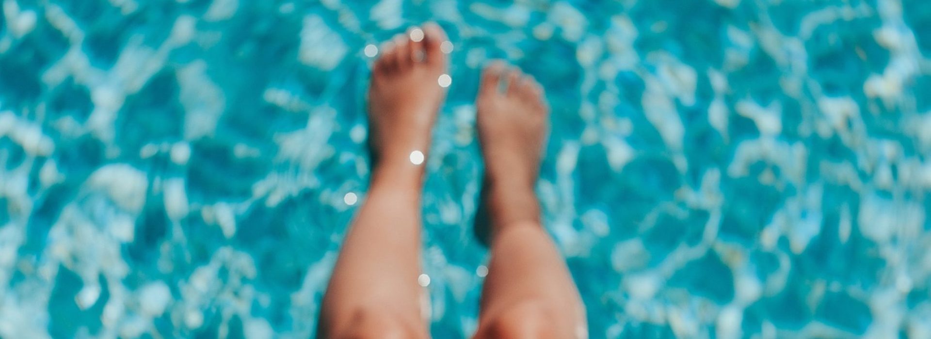 legs in swimming pool